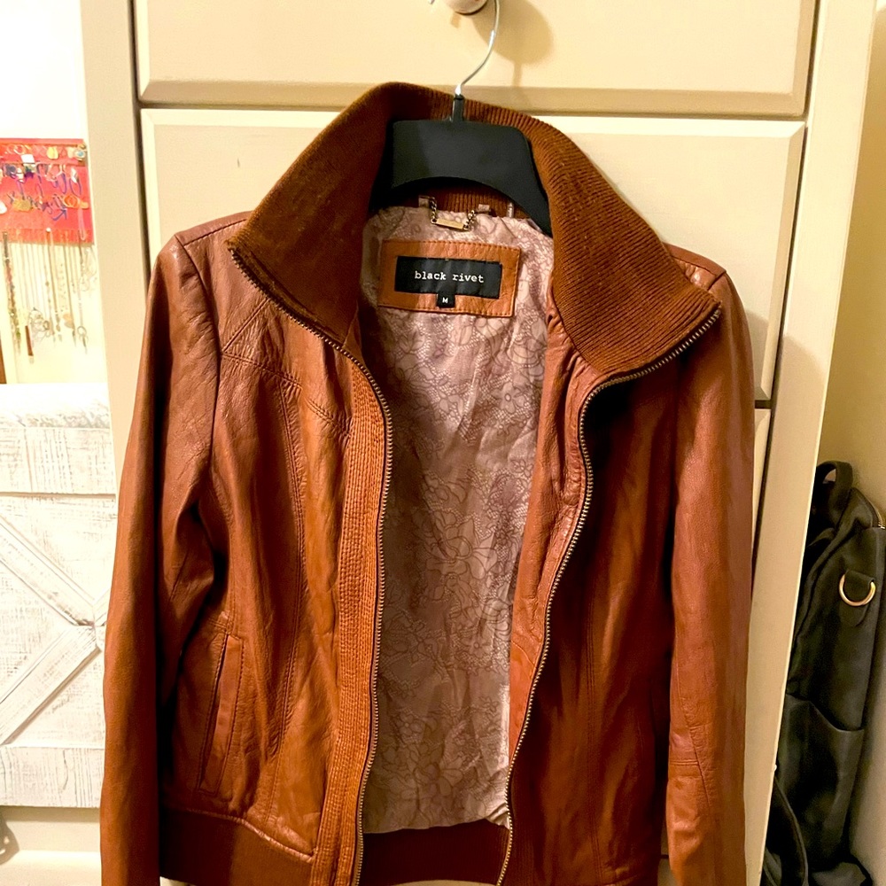 Black Rivet, brown leather jacket.
